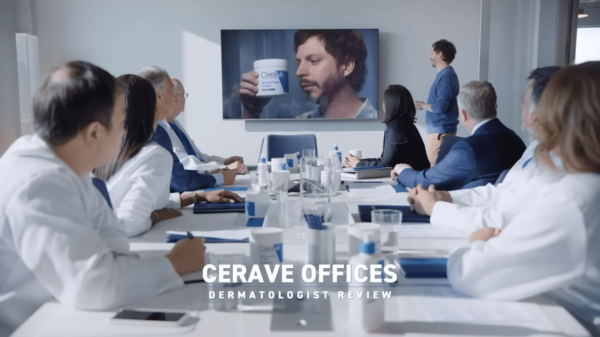 A screenshot from “Michael CeraVe” Superbowl video, with Michael Cera presenting a fictional advertisement to a team of dermatologists