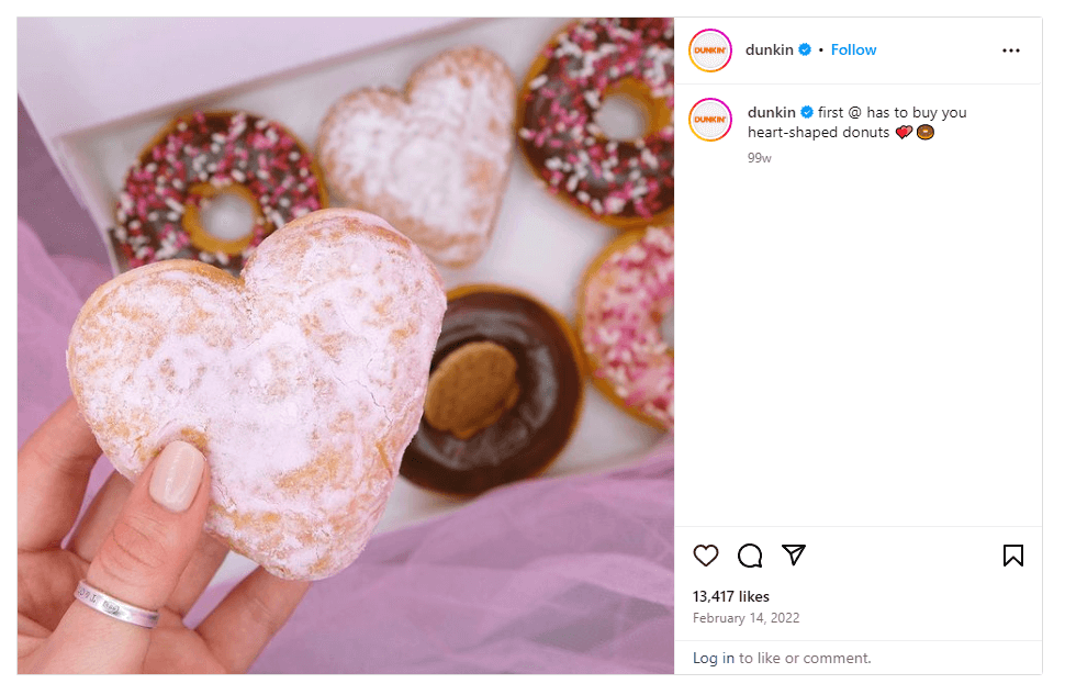 A screenshot of a post from Dunkin's Instagram profile offering to buy you heart-shaped donuts using a photo by a customer