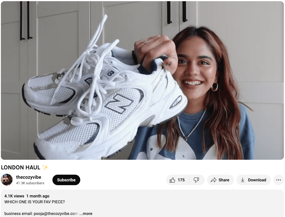Screenshot from the Youtube account thecozyvibe. London based influencer Pooja is smiling and holding some new trainers as she reviews what she recently bought on a shopping trip