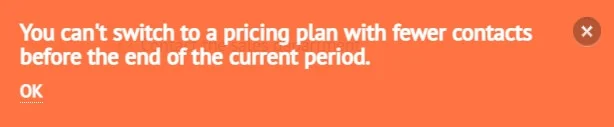 A notification pop-up states, “You can’t switch to a pricing plan with fewer contacts before the end of the current period.” The only available action is to press “OK”